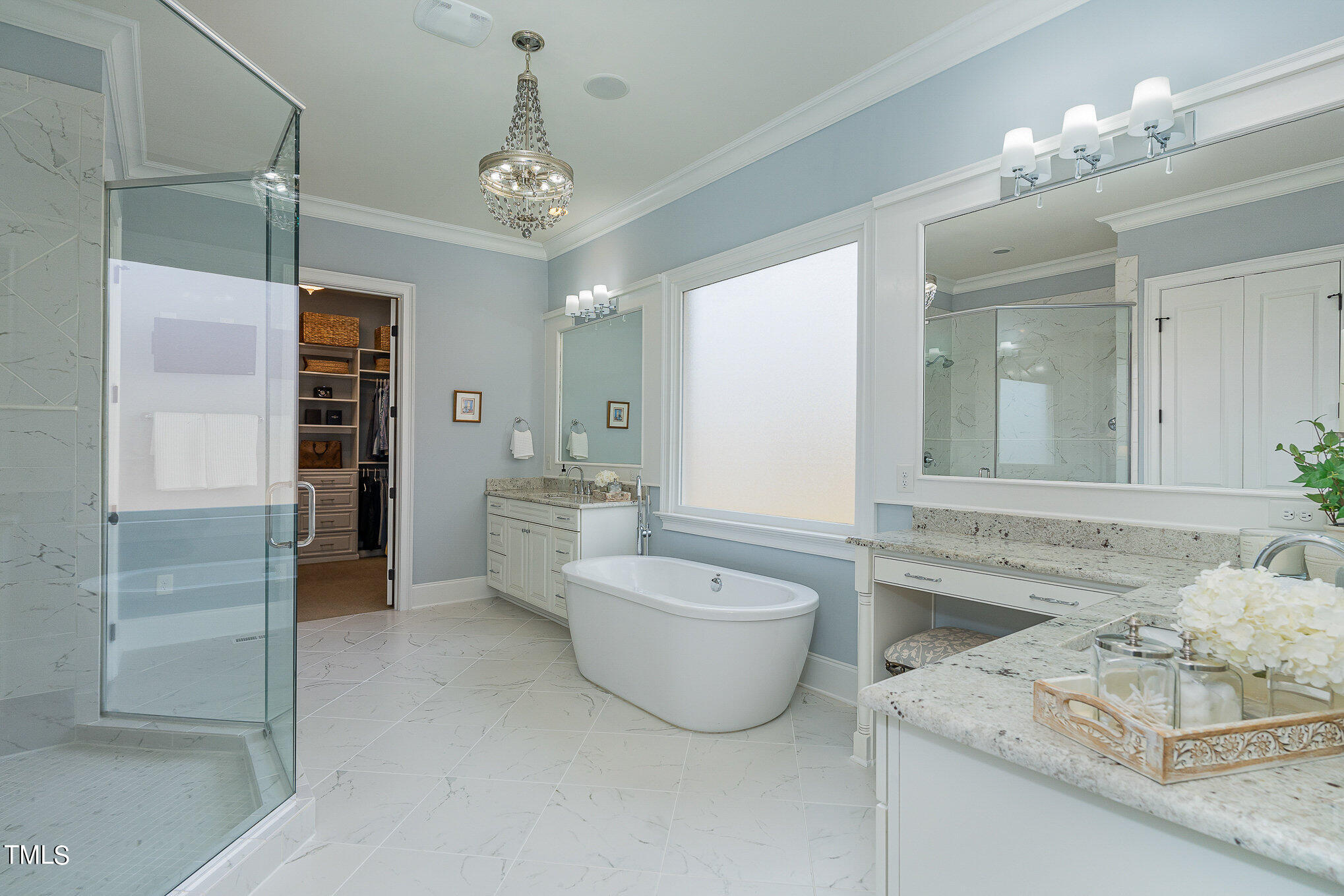 10632 Marion Stone Way Raleigh, NC 27614 - Photo 30 of 95 a spacious bathroom with a double vanity sink a large mirror and a bathtub