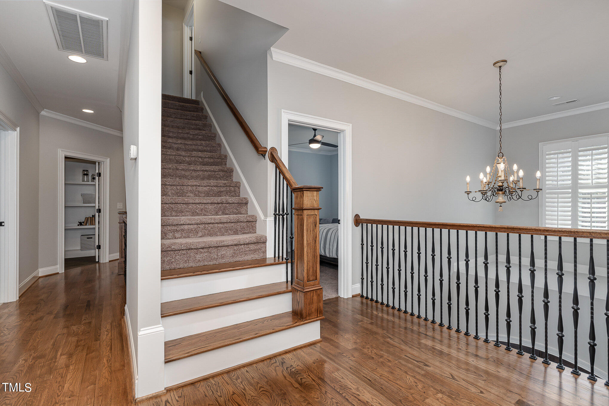 10632 Marion Stone Way Raleigh, NC 27614 - Photo 36 of 95 a view of a hallway with wooden floor and stairs