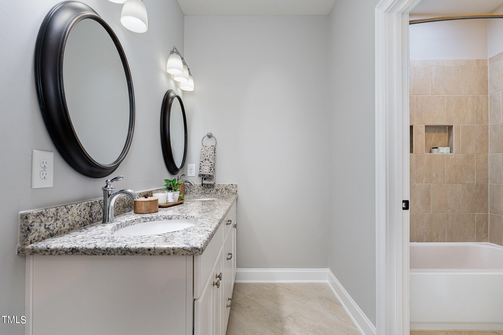 10632 Marion Stone Way Raleigh, NC 27614 - Photo 62 of 95 a bathroom with a granite countertop sink and a mirror