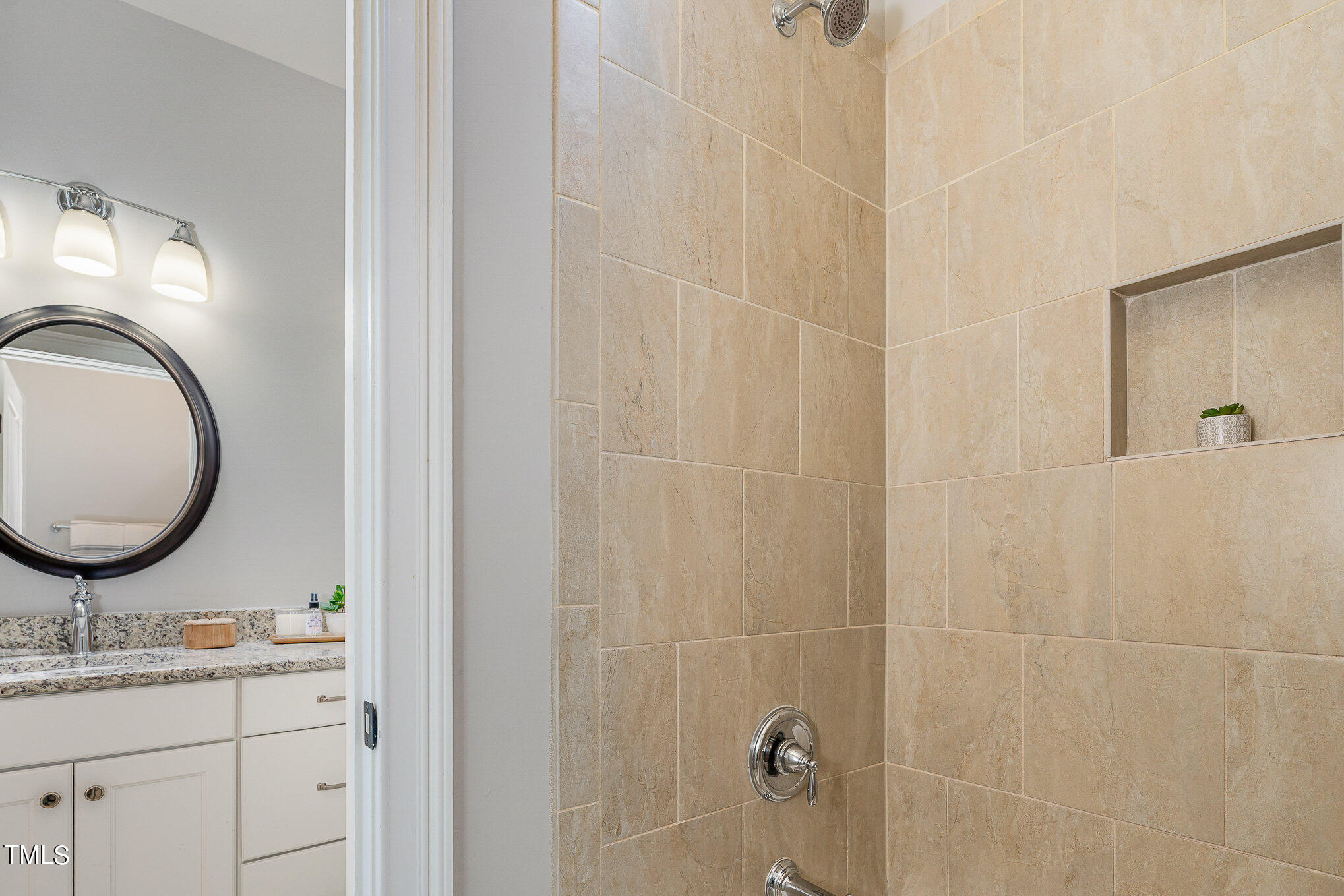 10632 Marion Stone Way Raleigh, NC 27614 - Photo 63 of 95 a bathroom with a granite countertop sink a mirror and vanity