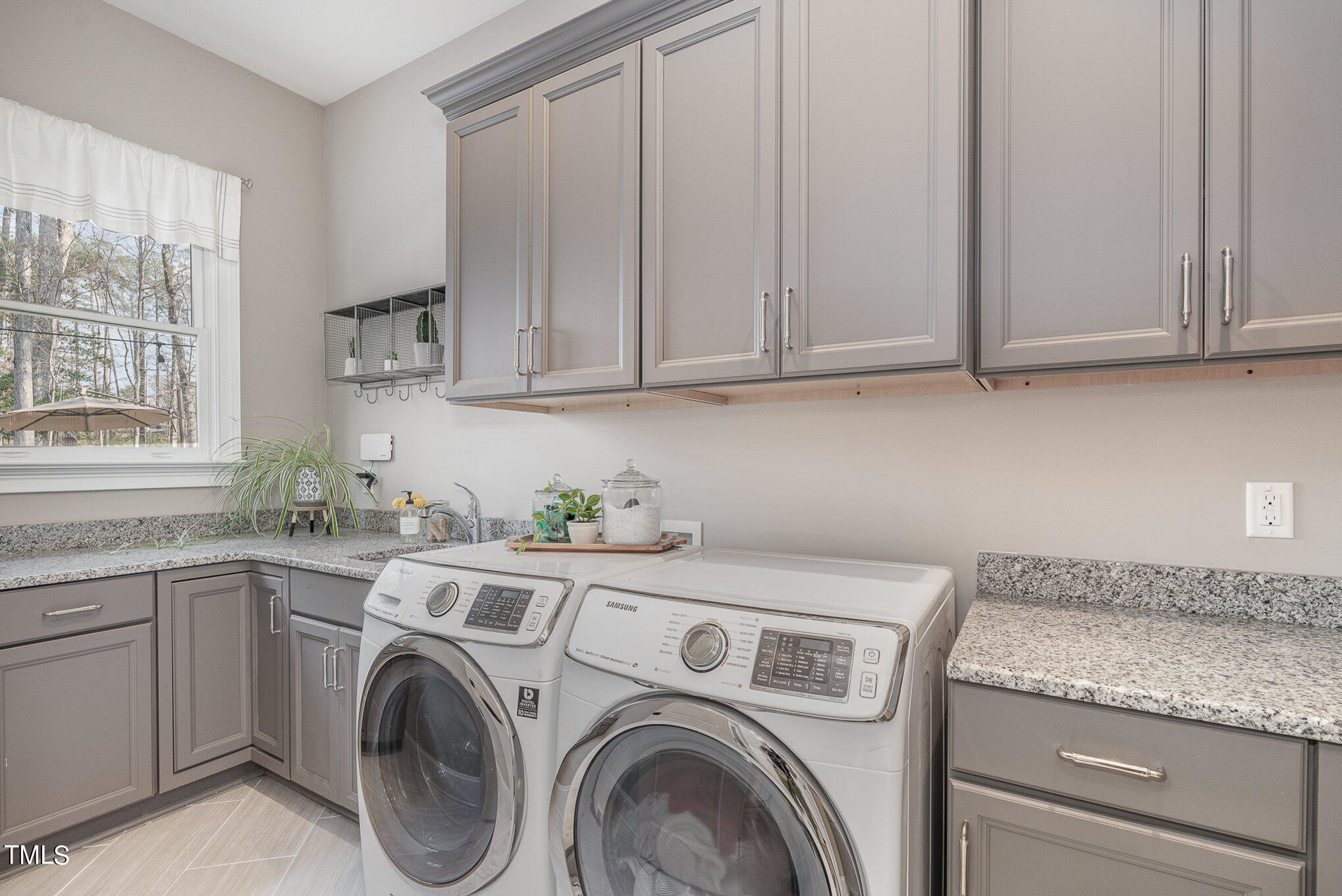 10632 Marion Stone Way Raleigh, NC 27614 - Photo 67 of 95 a utility room with stainless steel appliances granite countertop a sink a washer and dryer next to a window