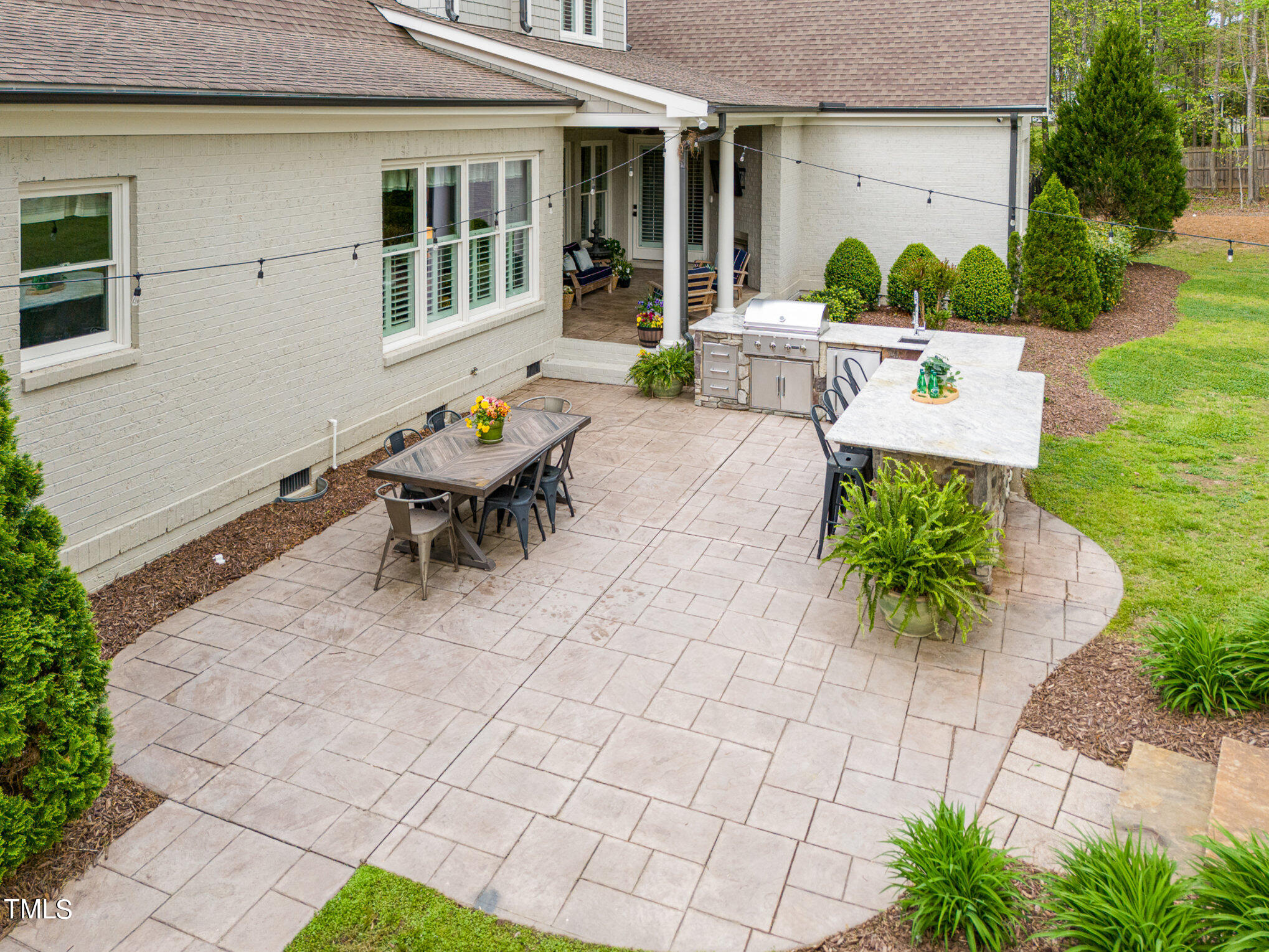 10632 Marion Stone Way Raleigh, NC 27614 - Photo 86 of 95 a view of a patio with table and chairs potted plants and large tree