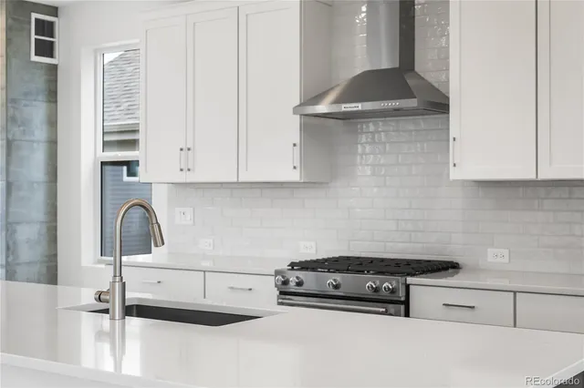 a kitchen with granite countertop a sink and a stove