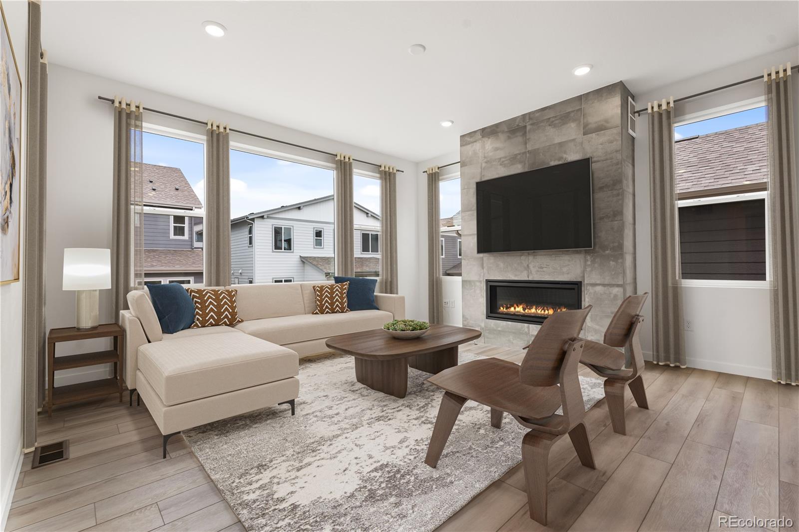 11972 Octave Avenue Lone Tree, CO 80134 - Photo 13 of 31 a living room with furniture a flat screen tv and a fireplace