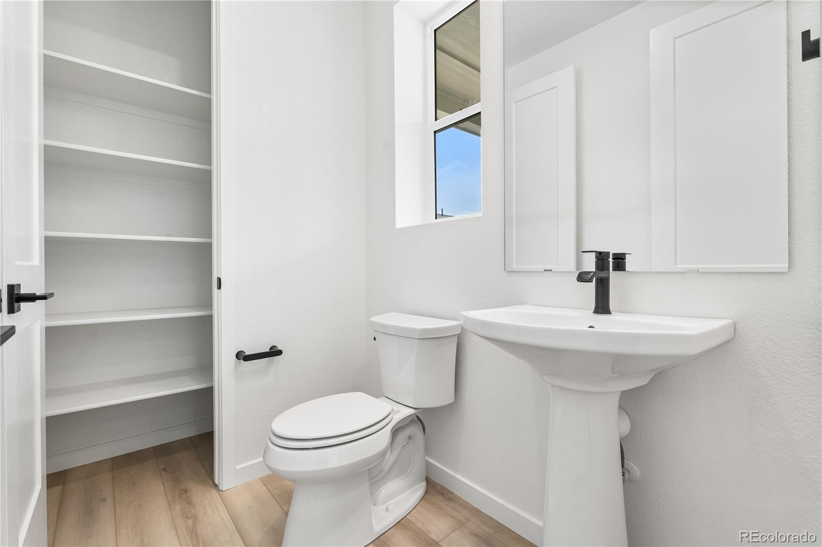11972 Octave Avenue Lone Tree, CO 80134 - Photo 23 of 31 a bathroom with a sink a toilet and a mirror