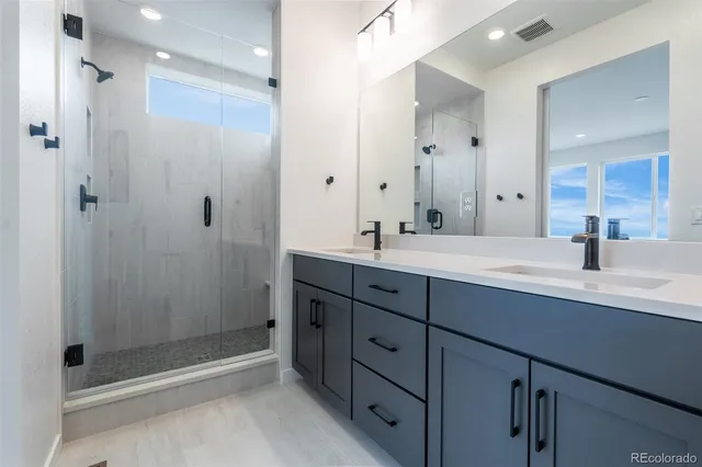 a bathroom with double sink and a mirror