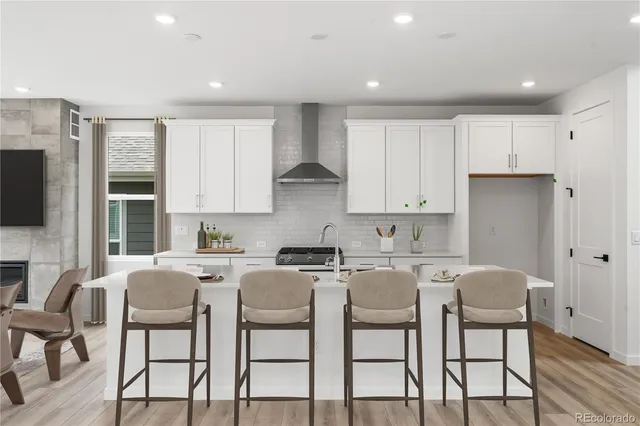 a kitchen with stainless steel appliances granite countertop a table and chairs in it
