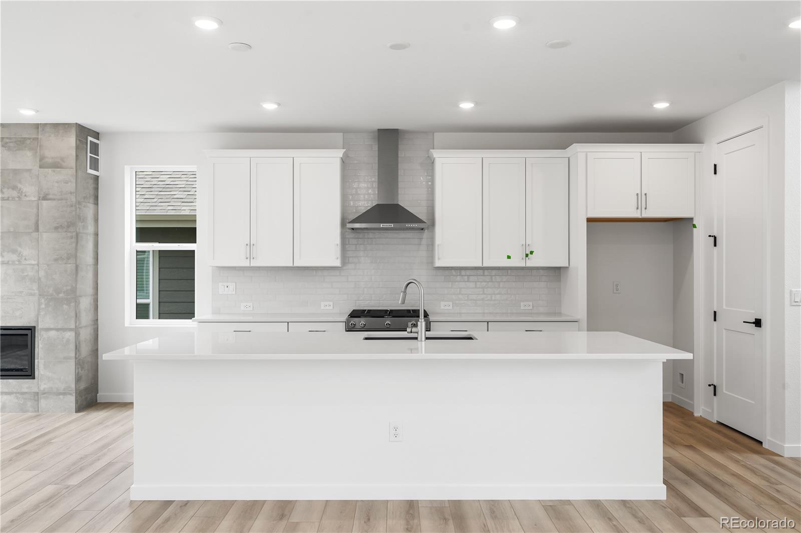 11972 Octave Avenue Lone Tree, CO 80134 - Photo 5 of 31 a kitchen with kitchen island sink stove and cabinets