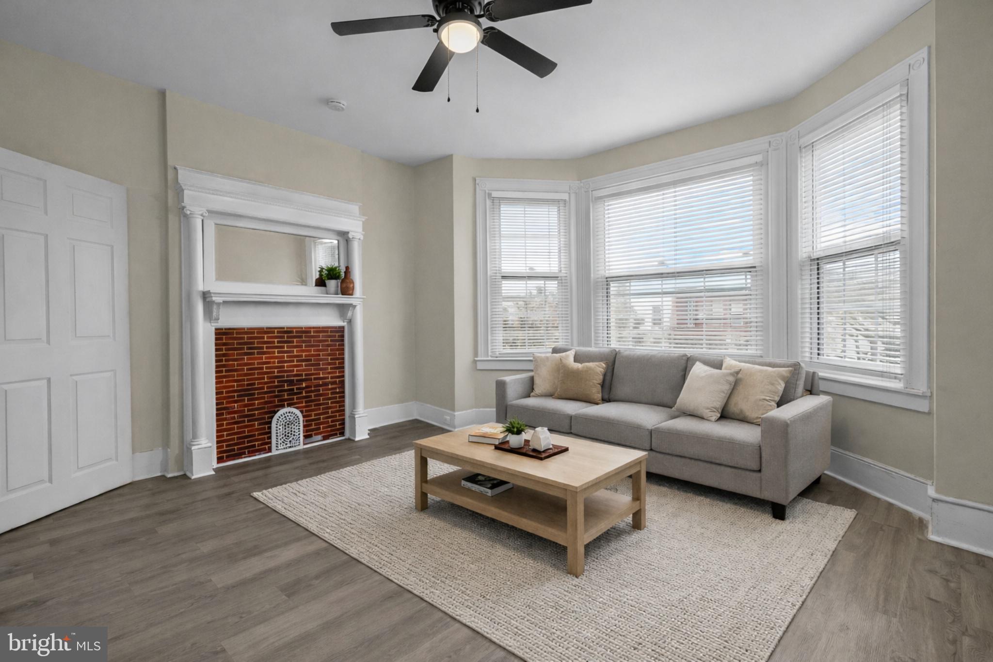 5723 Spruce Street, Unit 2 Philadelphia, PA 19139 - Photo 2 of 16 a living room with furniture and a fireplace