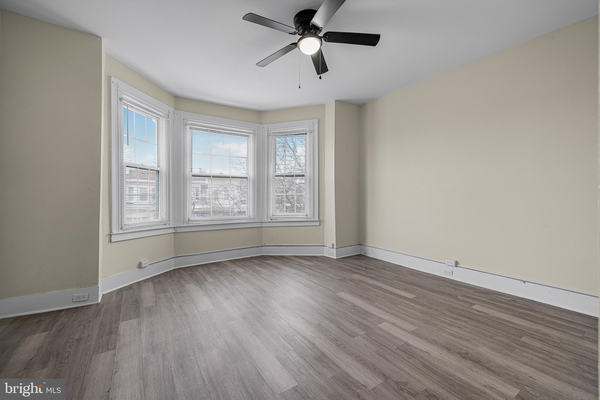 5723 Spruce Street, Unit 2 Philadelphia, PA 19139 - Photo 4 of 16 a view of an empty room with wooden floor and a window