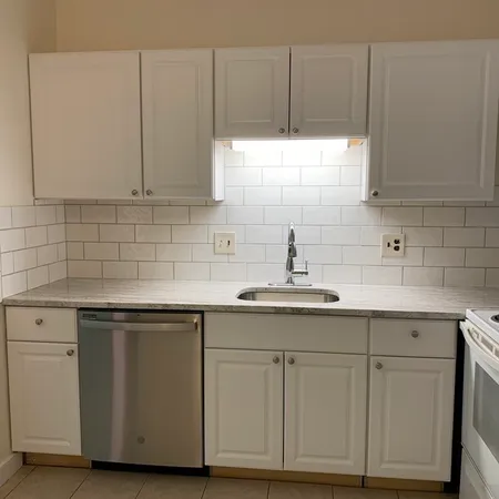 a kitchen with cabinets and white appliances