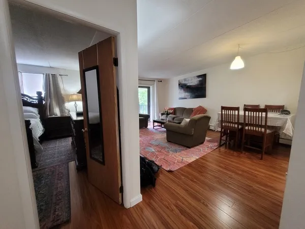 a living room with furniture and a wooden floor
