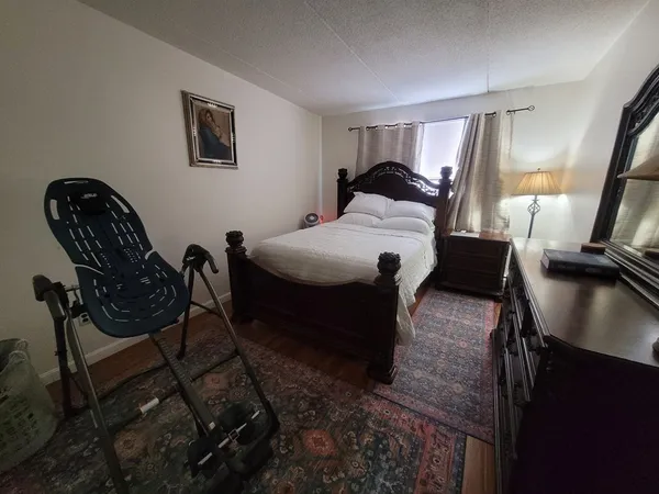 a bedroom with a bed a table and chair