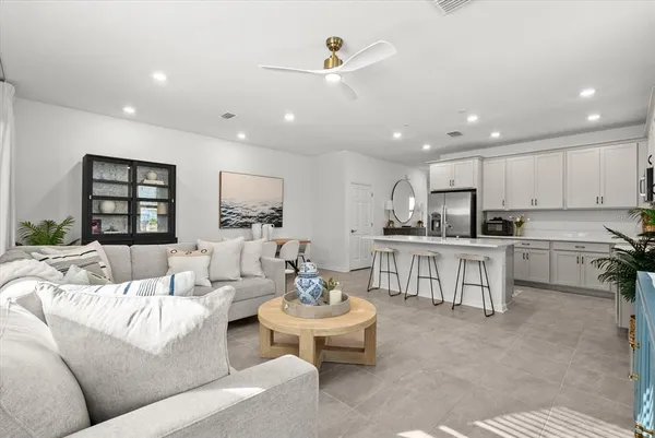 a kitchen with stainless steel appliances white cabinets and a refrigerator