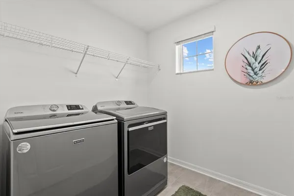 an aerial view of residential houses with yard