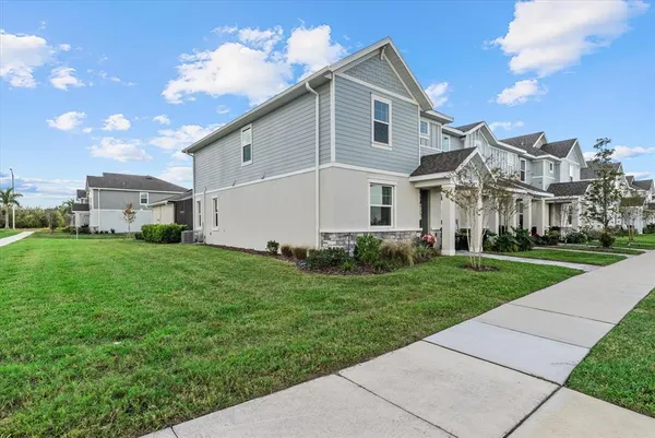 an aerial view of a swimming pool with outdoor seating