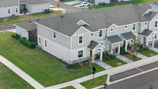 an aerial view of house with outdoor space and swimming pool