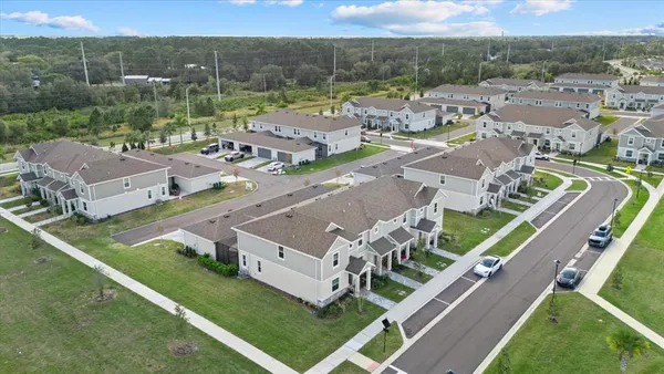 an aerial view of a house with a garden and swimming pool