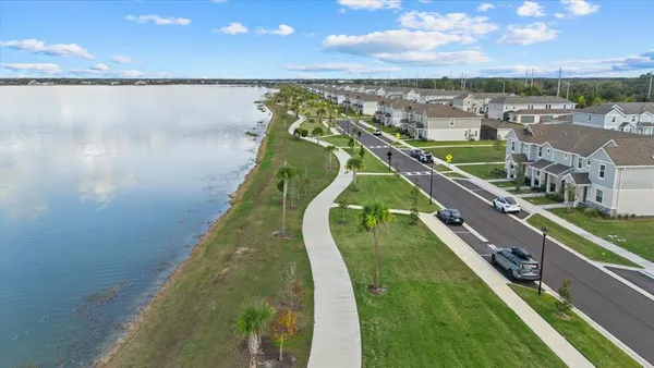 an aerial view of residential building with outdoor space and ocean view