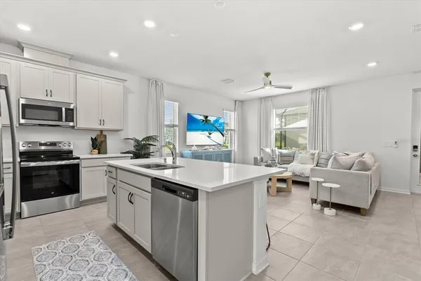 a living room with furniture and kitchen view
