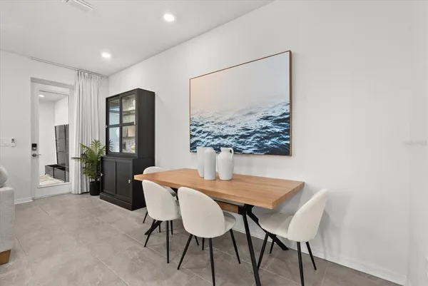 a living room with fireplace furniture and a view of kitchen