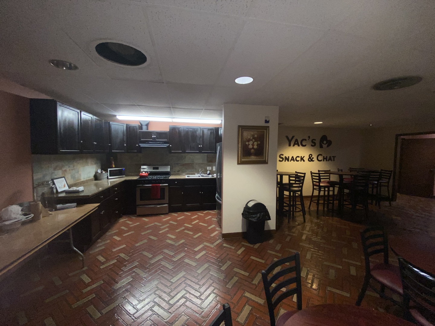 25 East 16th Street Chicago Heights, IL 60411 - Photo 12 of 13 a kitchen with stainless steel appliances kitchen island granite countertop a refrigerator a stove a sink a dining table and chairs with wooden floor