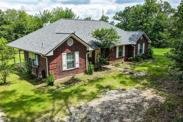 a front view of house with yard and green space