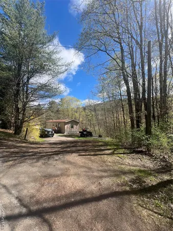 a view of a yard with yellow house