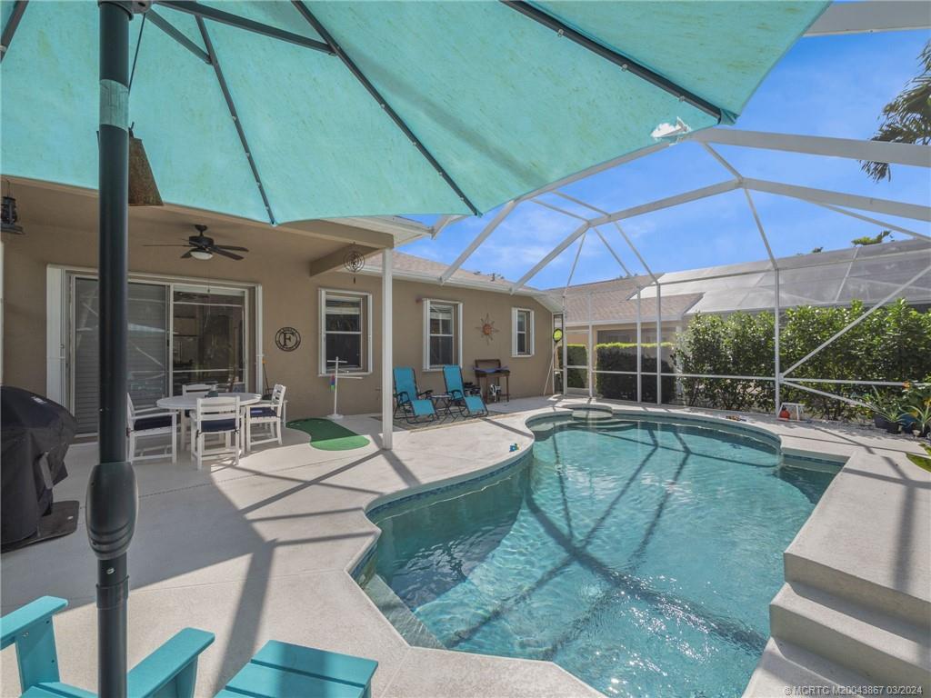 2432 Southeast Springtree Place Stuart, FL 34997 - Photo 21 of 24 a view of a house with backyard porch and patio