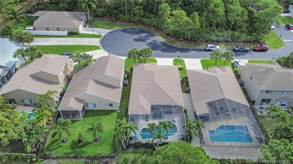 2432 Southeast Springtree Place Stuart, FL 34997 - Photo 4 of 24 an aerial view of a house with outdoor space and a swimming pool