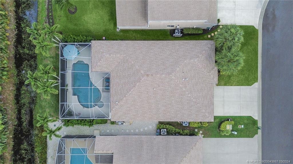 2432 Southeast Springtree Place Stuart, FL 34997 - Photo 5 of 24 an aerial view of a house with a yard and potted plants