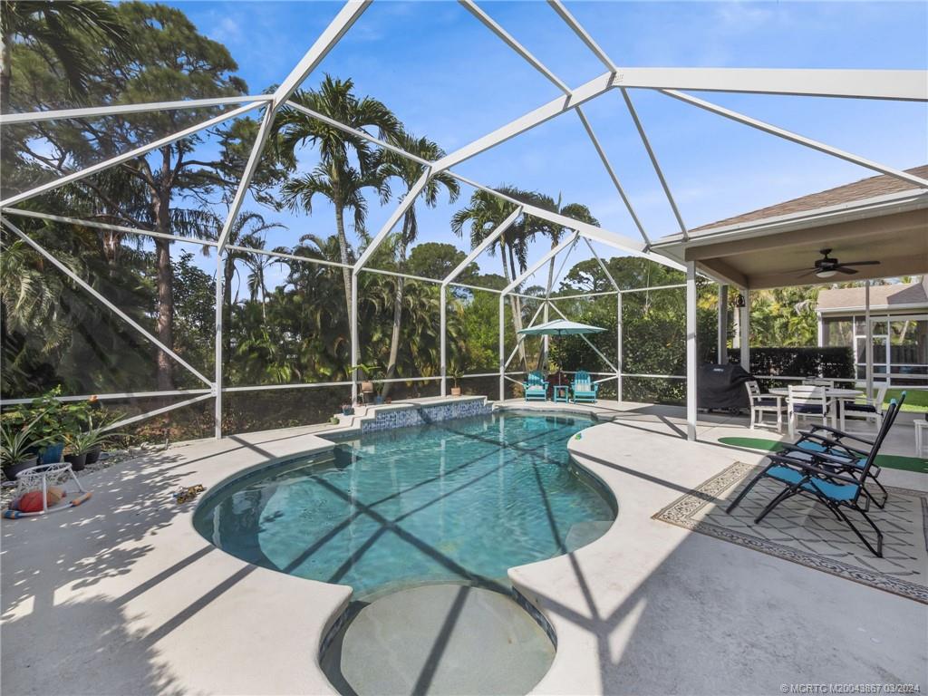 2432 Southeast Springtree Place Stuart, FL 34997 - Photo 10 of 24 a view of a swimming pool with a patio