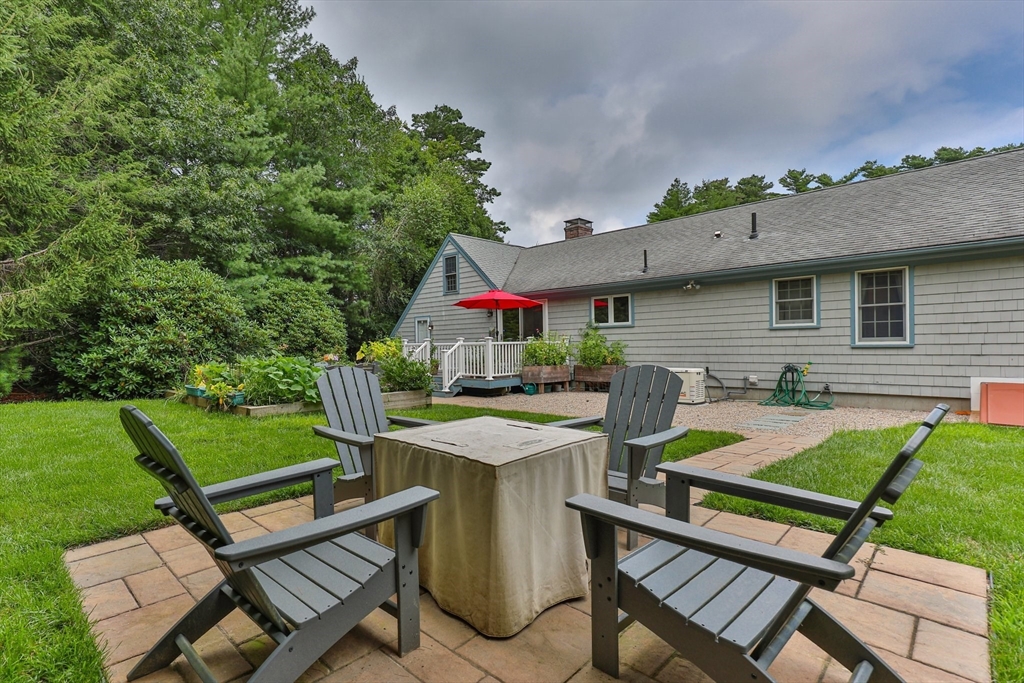 a view of a patio with table and chairs under an umbrella
