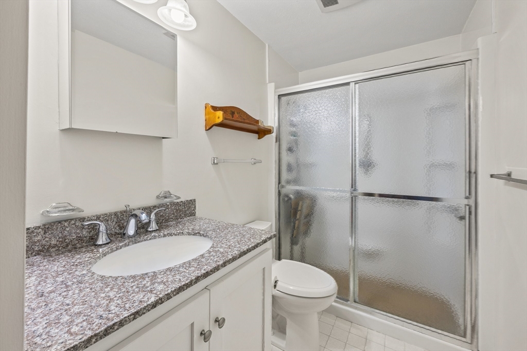 51 Poplar Drive Barnstable, MA 02655 - Photo 18 of 23 a bathroom with a granite countertop sink toilet and shower