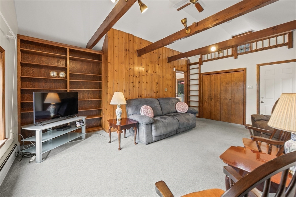 51 Poplar Drive Barnstable, MA 02655 - Photo 5 of 23 a living room with furniture a flat screen tv and gym equipment