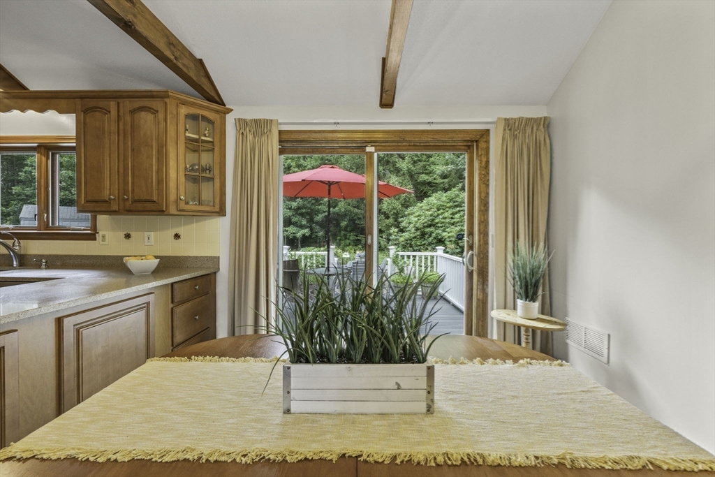 51 Poplar Drive Barnstable, MA 02655 - Photo 8 of 23 a kitchen with a sink and wooden cabinets