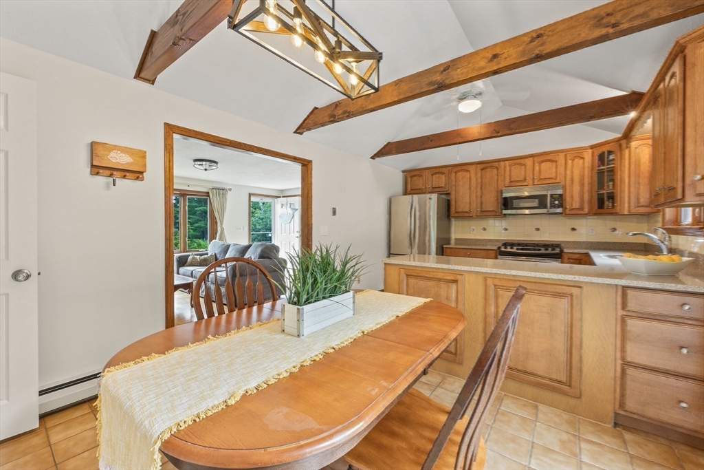 51 Poplar Drive Barnstable, MA 02655 - Photo 9 of 23 a kitchen with a table chairs a stove and cabinets