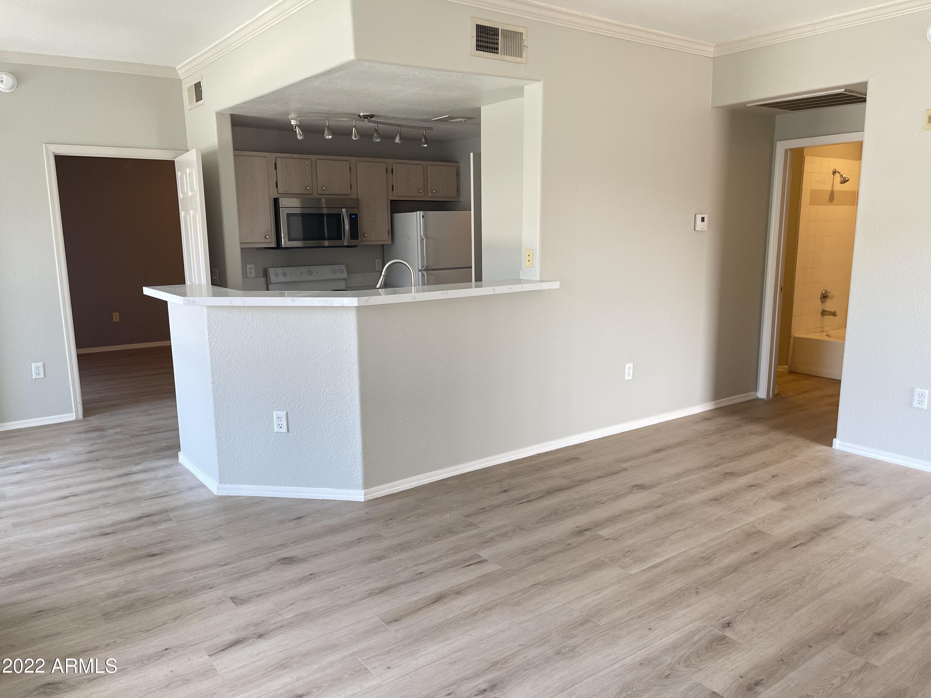 3236 East Chandler Boulevard, Unit 2093 Phoenix, AZ 85048 - Photo 2 of 28 a view of living room with wooden floor