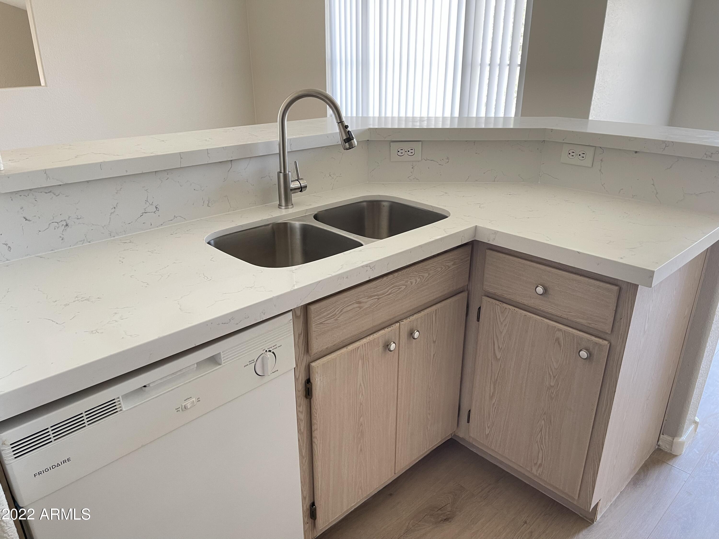 3236 East Chandler Boulevard, Unit 2093 Phoenix, AZ 85048 - Photo 5 of 28 a kitchen with sink and cabinets