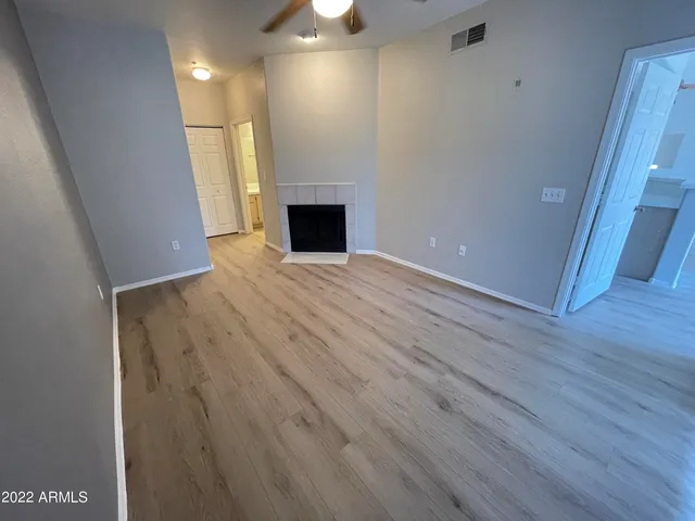wooden floor in an empty room with a fireplace