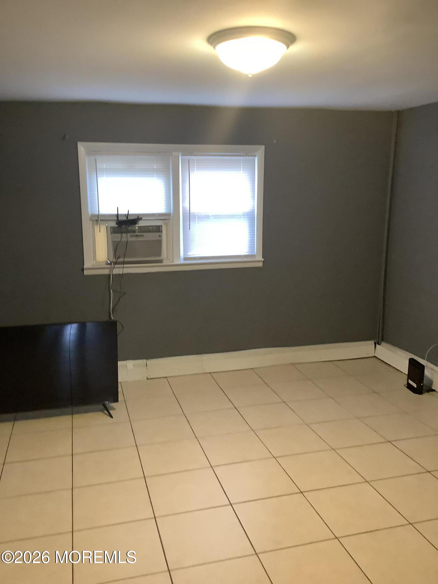 242 1st Street Keyport, NJ 07735 - Photo 7 of 23 a view of an empty room and window