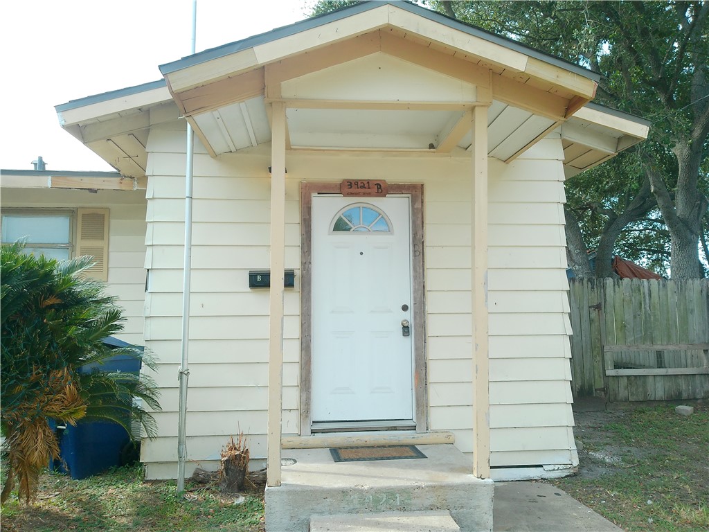 3921 Chestnut Street, Unit B Corpus Christi, TX 78411 - Photo 1 of 5 a front view of a house with a yard