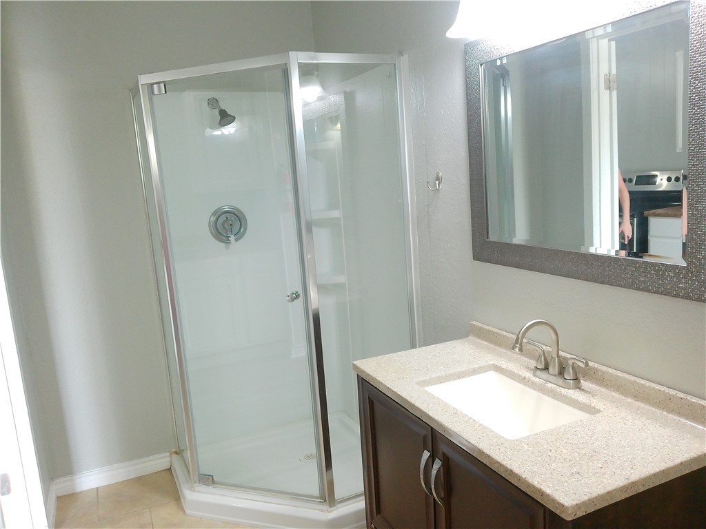 3921 Chestnut Street, Unit B Corpus Christi, TX 78411 - Photo 3 of 5 a bathroom with a sink and a mirror