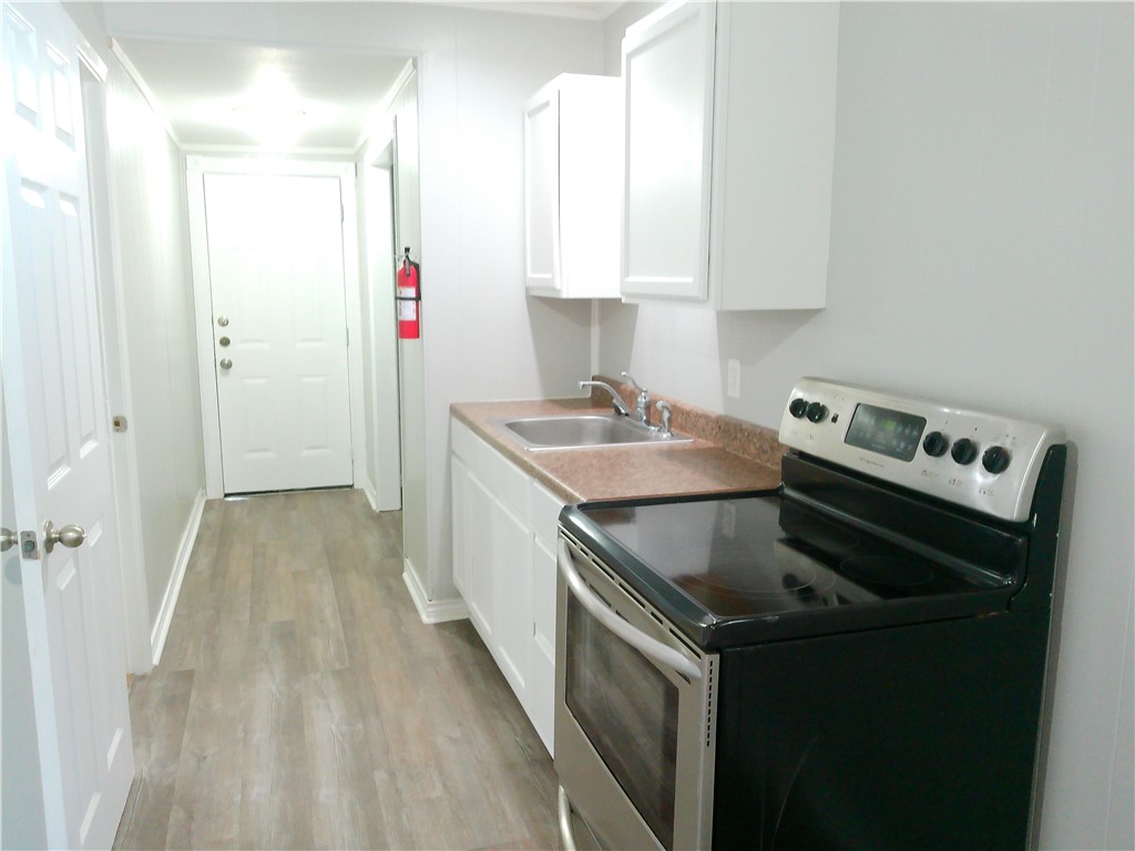 3921 Chestnut Street, Unit B Corpus Christi, TX 78411 - Photo 5 of 5 a kitchen that has a sink and a stove in it