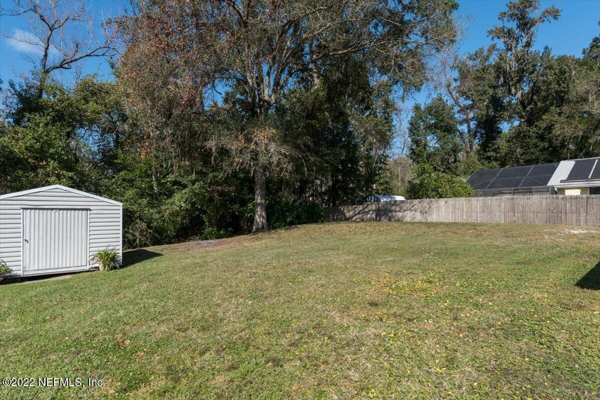 2124 Rothbury Drive Jacksonville, FL 32221 - Photo 23 of 27 a view of a backyard with large trees