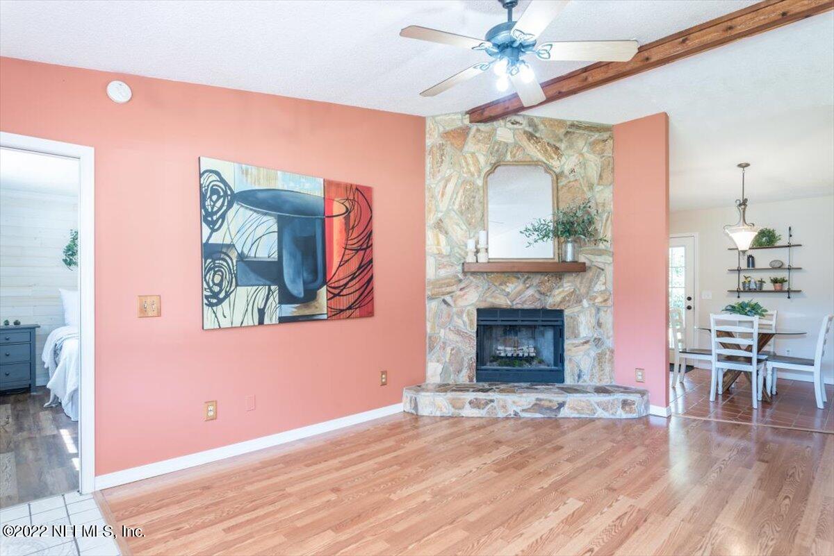 2124 Rothbury Drive Jacksonville, FL 32221 - Photo 6 of 27 a view of a livingroom with furniture wooden floor a fireplace and chandelier