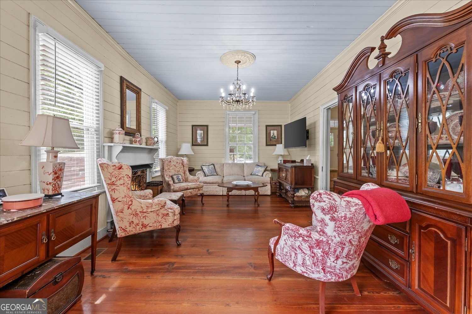 6644 East Cadley Road Norwood, GA 30821 - Photo 19 of 53 a living room with fireplace furniture and a chandelier