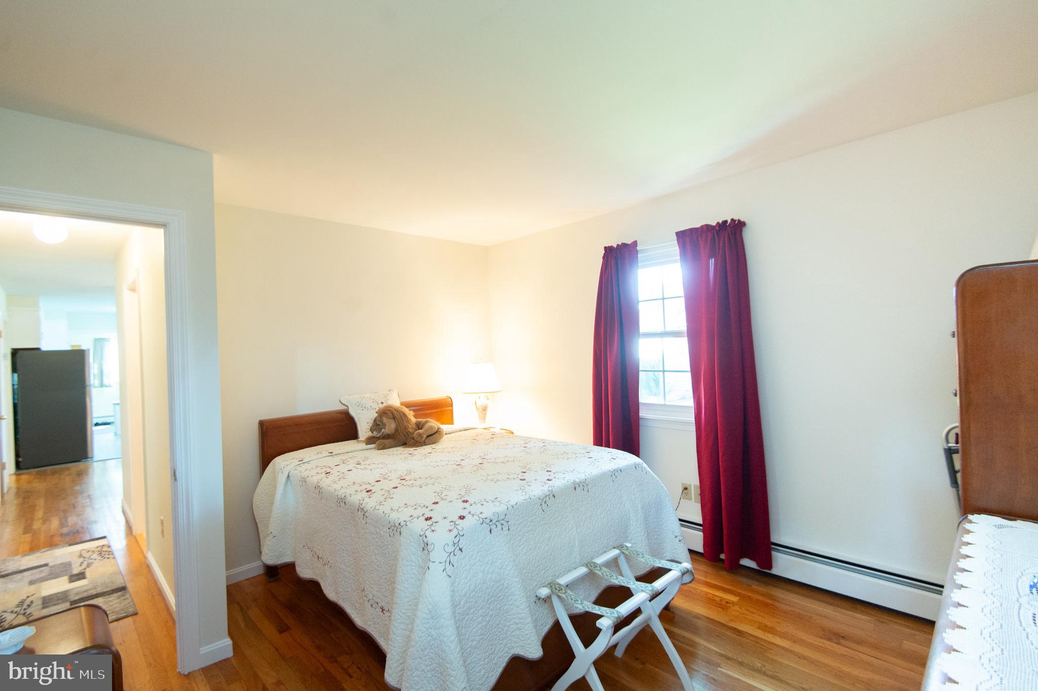 8 West Liberty Street Ridgely, MD 21660 - Photo 25 of 55 a bedroom with a bed and wooden floor