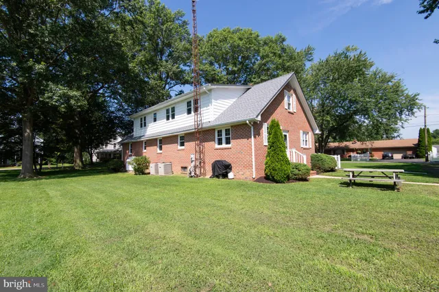 a view of a house with backyard space and sitting area