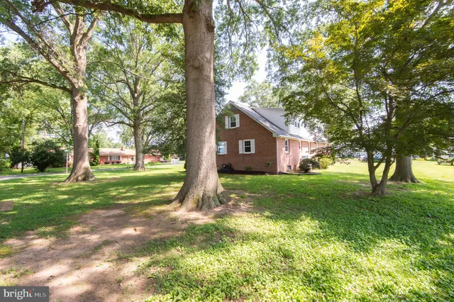 a swimming pool with an outdoor space and seating area